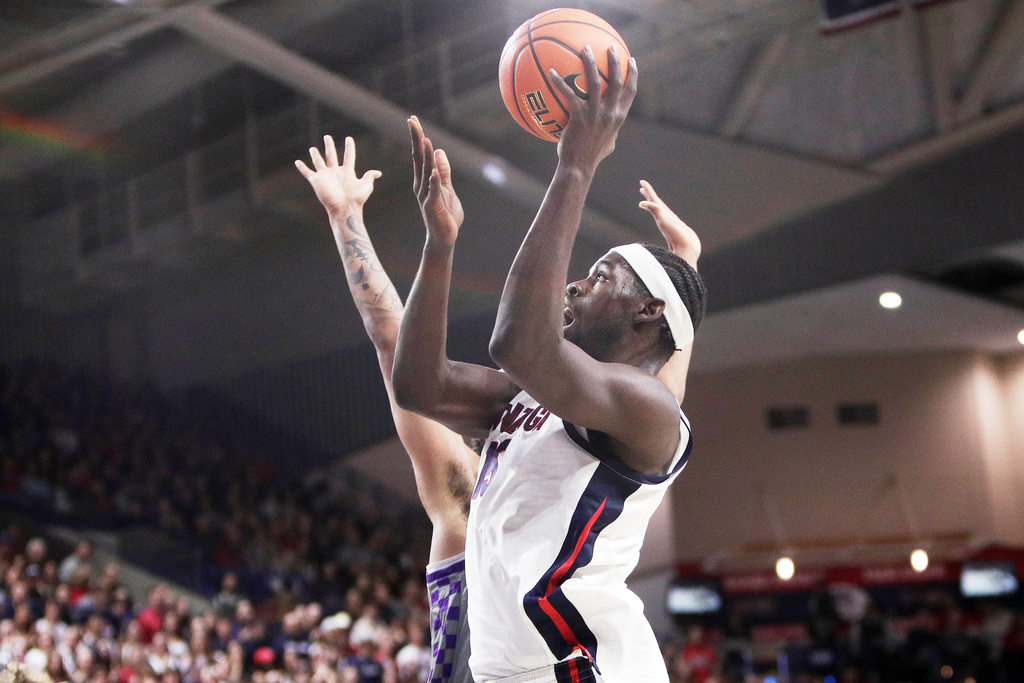 Gonzaga forward Graham Ike, front, shoots while pressured by Portland center Jermaine Ballisager Webb during the first half of an NCAA college basketball game, Wednesday, Feb. 25, 2026, in Spokane, Wash. (AP Photo/Young Kwak)