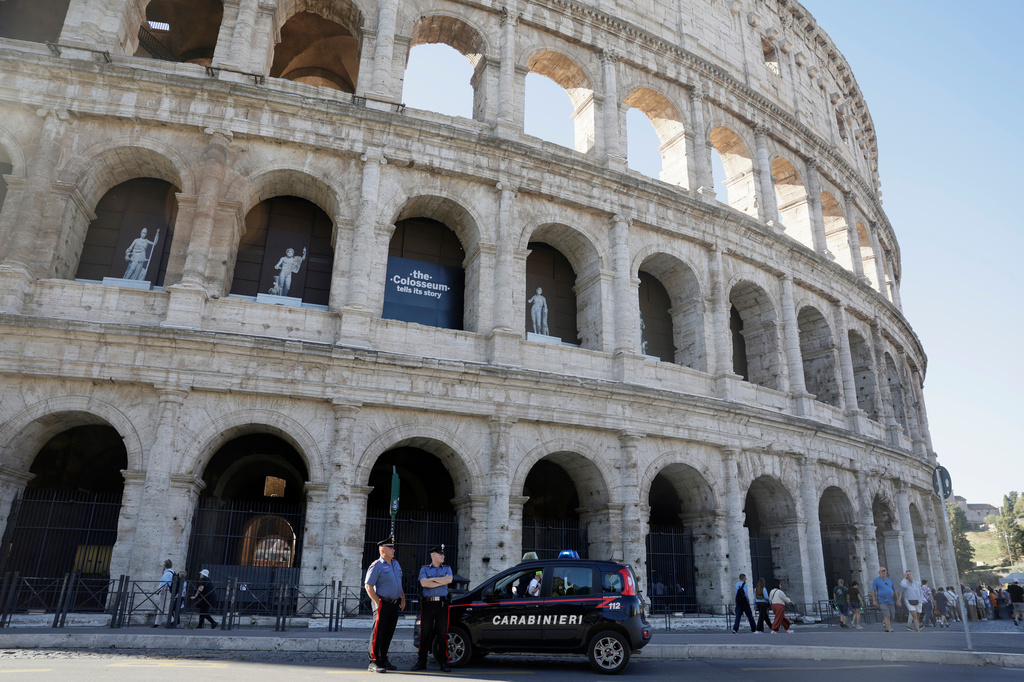 Carabinieri paramilitary police stand on patrol outside the Colosseum, closed to the public for the day to mourn a worker who fell to his death late Tuesday when installing cabling inside the ancient amphitheater, in Rome, Wednesday, Sept. 23, 2026. (Cecilia Fabiano/LaPresse via AP)