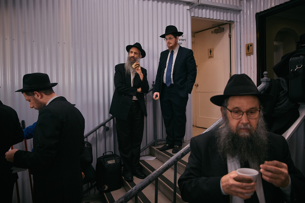 Chabad-Lubavitch rabbis take a break near the resting place of the Rebbe, Rabbi Menachem M. Schneerson, one of Judaism’s most influential figures, in the Queens borough of New York on Friday, Nov. 14, 2025, during the International Conference of Chabad-Lubavitch Emissaries. (AP Photo/Andres Kudacki)
