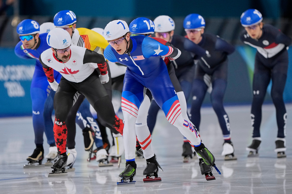 Jordan Stolz of the U.S., center, Antoine Gelinas-Beaulieu of Canada, left, and Andrea Giovannini of Italy, far left, compete in the men's mass start final speedskating race at the 2026 Winter Olympics, in Milan, Italy, Saturday, Feb. 21, 2026. (AP Photo/Ben Curtis)