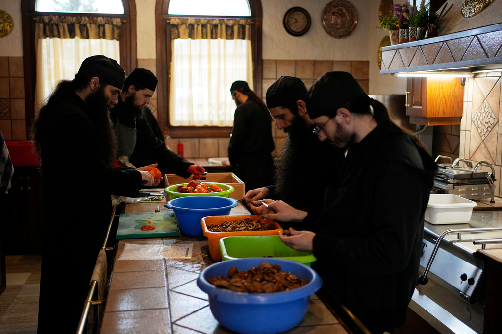 Monks prepare the meals at the Monastery of St. Augustine and Seraphim of Sarov in the village of Trikorfo, about 236 kilometers (147 miles) northwest of Athens, Friday, March 20, 2026. (AP Photo/Thanassis Stavrakis)