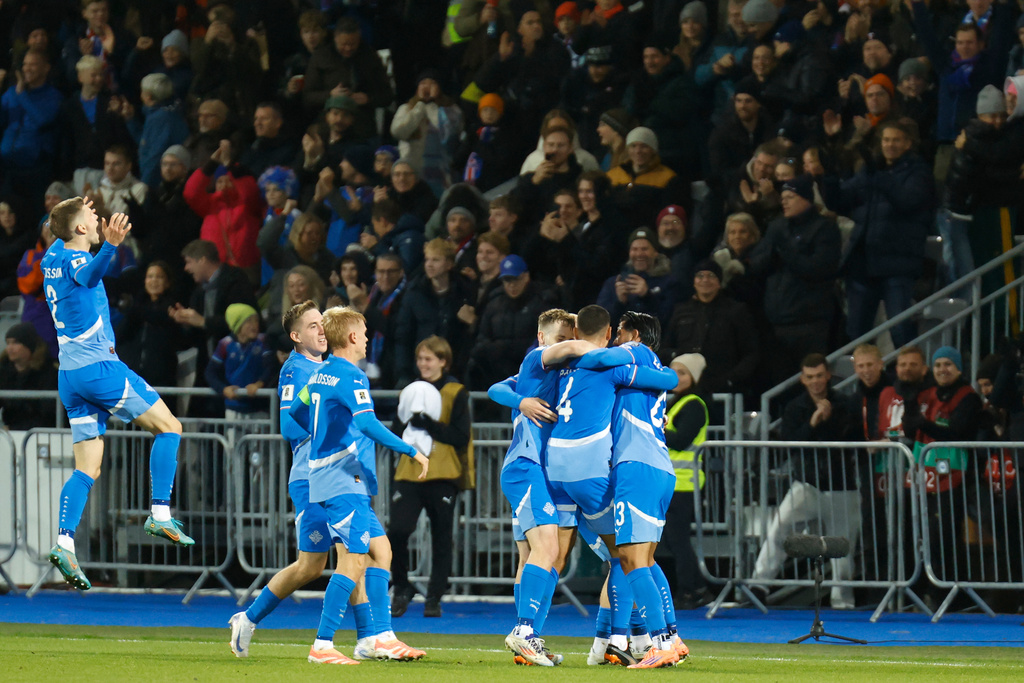 Iceland players celebrate after Victor Palsson, 2nd right, scored the opening goal during a World Cup 2026 group D qualifying soccer match between Iceland and France in Reykjavik, Monday, Oct. 13, 2025. (AP Photo/Brynjar Gunnarsson)