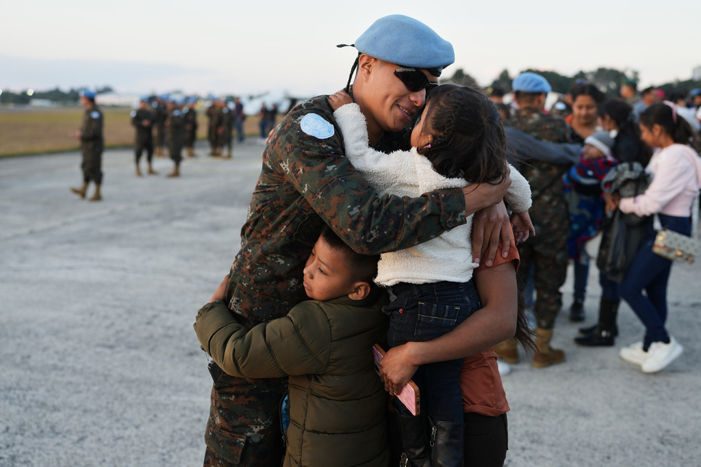 FILE - A soldier embraces his family during a farewell ceremony in Guatemala City, Jan. 31, 2026, before traveling to join the United Nations peacekeeping force in the Democratic Republic of the Congo. (AP Photo/Moises Castillo, File)