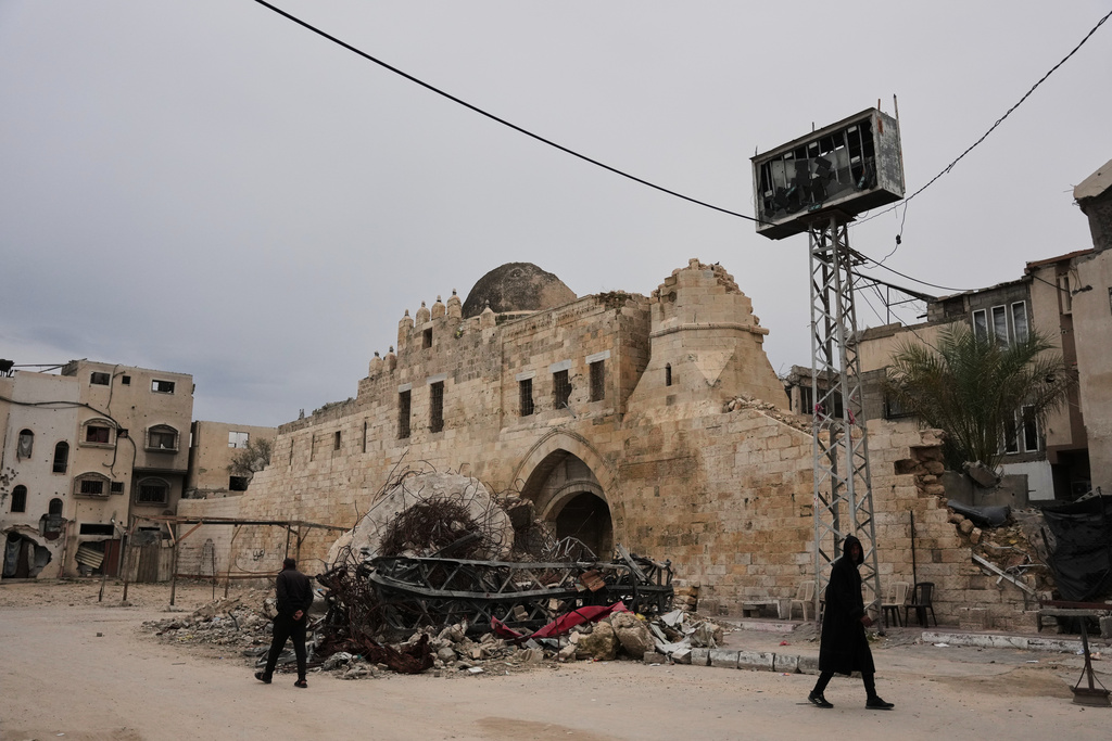 Palestinians walk in front of the Barqouq Castle in Khan Younis, southern Gaza Strip after it was damaged during the Israel-Hamas war Thursday, Jan. 22, 2026. (AP Photo/Abdel Kareem)