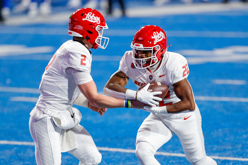 New Mexico running back Scottre Humphrey (22) receives the ball on a handoff from quarterback Jack Layne (2) against Boise State in the first half of an NCAA college football game, Saturday, Oct. 11, 2025, in Boise, Idaho. (AP Photo/Steve Conner) New Mexico running back Scottre Humphrey (22) receives the ball on a handoff from quarterback Jack Layne (2) against Boise State in the first half of an NCAA college football game, Saturday, Oct. 11, 2025, in Boise, Idaho. (AP Photo/Steve Conner)