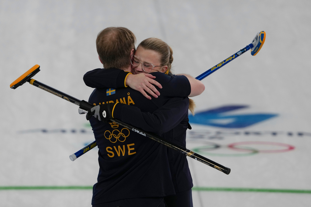 Sweden's Rasmus Wranaa and Isabella Wranaa celebrate after winning the gold medal mixed doubles curling match against USA, at the 2026 Winter Olympics, in Cortina D'Ampezzo, Italy, Tuesday, Feb. 10, 2026. (AP Photo/Misper Apawu)