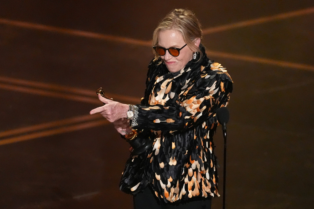 Amy Madigan accepts the award for actress in a supporting role for "Weapons" during the Oscars on Sunday, March 15, 2026, at the Dolby Theatre in Los Angeles. (AP Photo/Chris Pizzello)