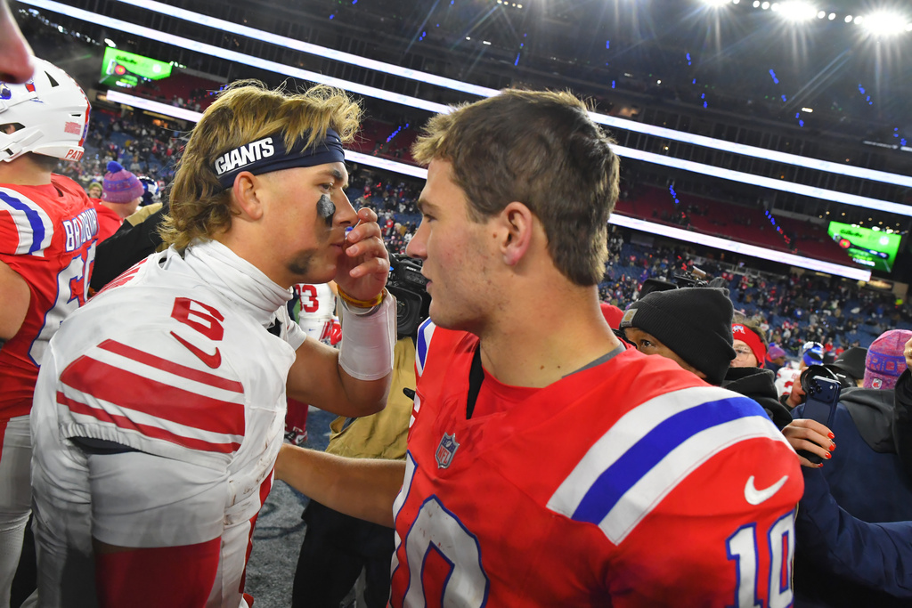 New York Giants quarterback Jaxson Dart (6) and New England Patriots quarterback Drake Maye (10) talk following an NFL football game Monday, Dec. 1, 2025, in Foxborough, Mass. (AP Photo/Steven Senne)