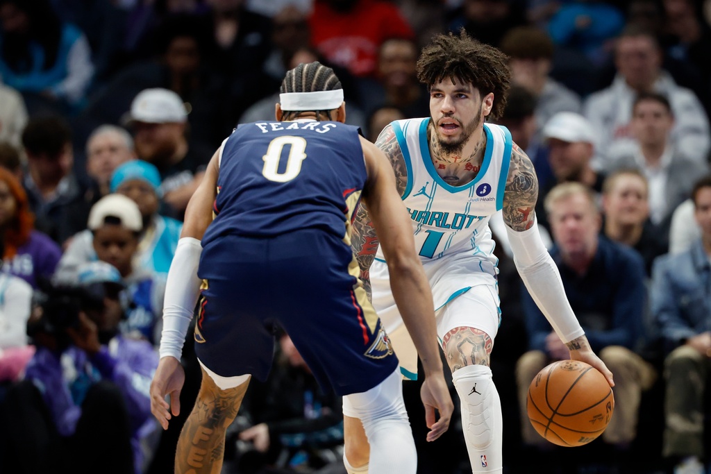 Charlotte Hornets guard LaMelo Ball (1) brings the ball upcourt against New Orleans Pelicans guard Jeremiah Fears (0) during the first half of an NBA basketball game in Charlotte, N.C., Monday, Feb. 2, 2026. (AP Photo/Nell Redmond)