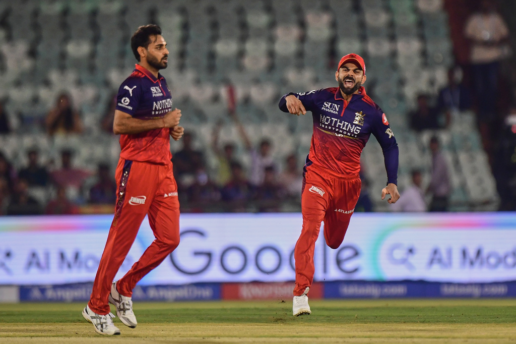 Royal Challengers Bengaluru's Virat Kohli, right and Bhuvneshwar Kumar celebrates the wicket of Kolkata Knight Riders' Finn Allen during the Indian Premier League cricket match between Royal Challengers Bengaluru and Kolkata Knight Riders in Raipur, India, Wednesday, May 13, 2026. (AP Photo/Abhijit Addya)
