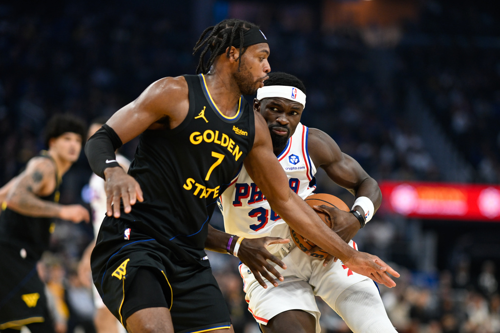 Philadelphia 76ers center Adem Bona (30) drives to the basket against Golden State Warriors guard Buddy Hield (7) during the first half of an NBA basketball game, Tuesday, Feb. 3, 2026, in San Francisco. (AP Photo/Eakin Howard)