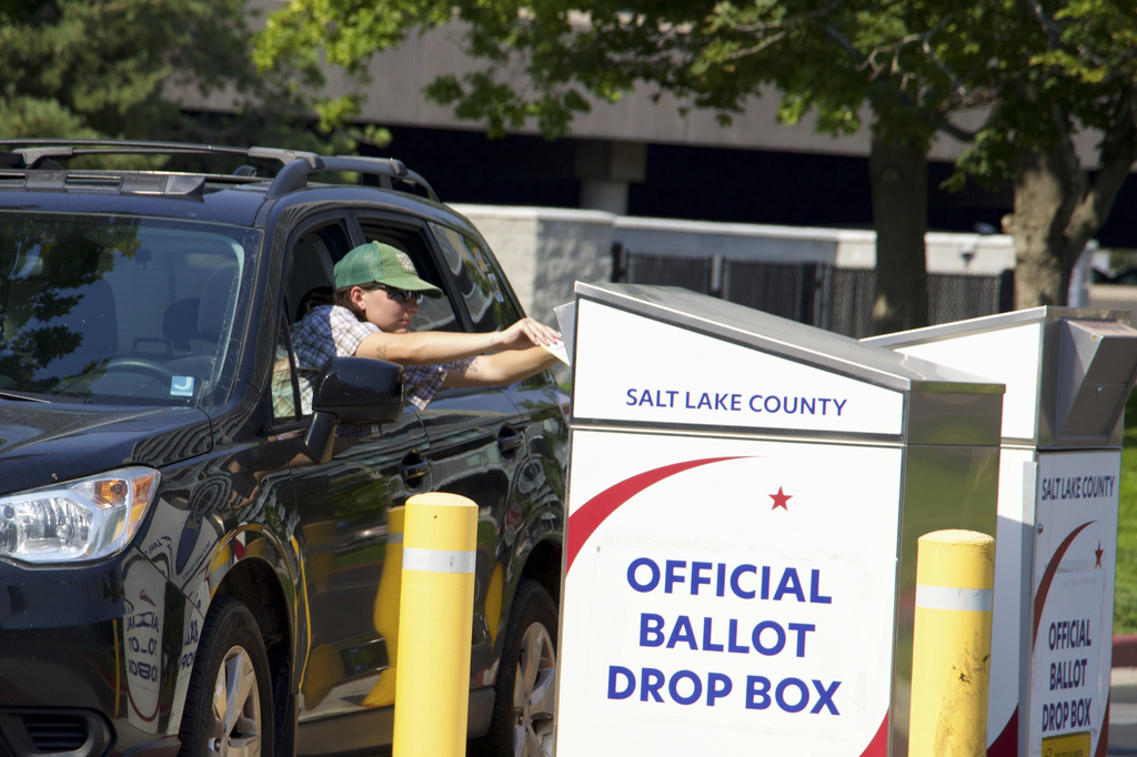 A Utah voter places a ballot in a drop box outside the Salt Lake County Government Center in Salt Lake City, Tuesday, June 23, 2026. (AP Photo/Hannah Schoenbaum)