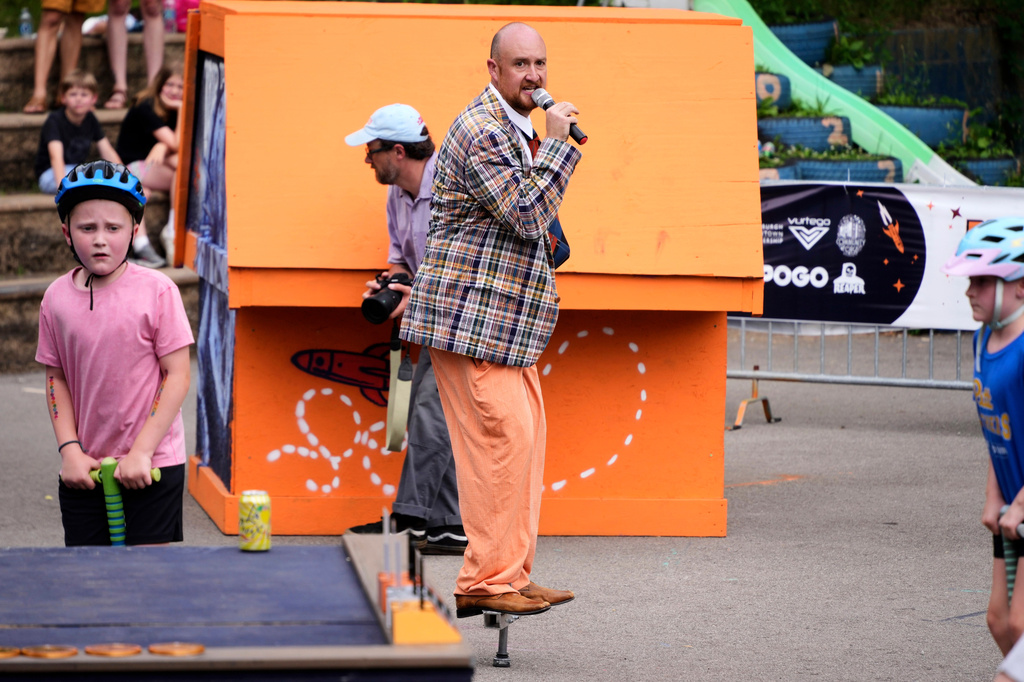 Will Weiner, producer and CEO of XPogo, center, pogos as he mc's a pogo event for neighborhood youngsters following the conclusion of competition at Pogopalooza 2026 in Wilkinsburg, Pa., Thursday, June 11, 2026. (AP Photo/Gene J. Puskar)