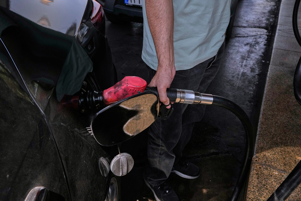 A man is filling up his car at a gas station in Tehran, Iran, Tuesday, Aug. 25, 2026. (AP Photo/Vahid Salemi)