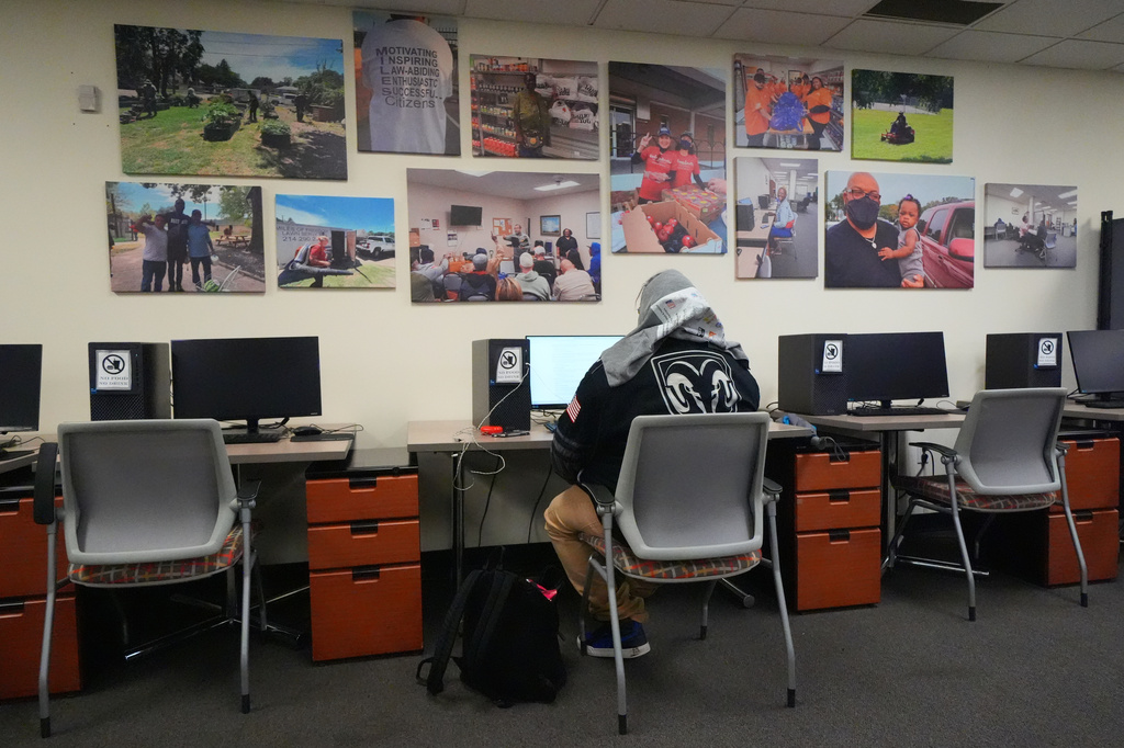 Joe Gorostiza uses a computer at Miles of Freedom, a Dallas-based group that provides help for individuals after they have been released from prison, whether they are on parole or are exonerees, while looking for job opportunities online Tuesday, April 21, 2026 in Dallas. (AP Photo/Julio Cortez)