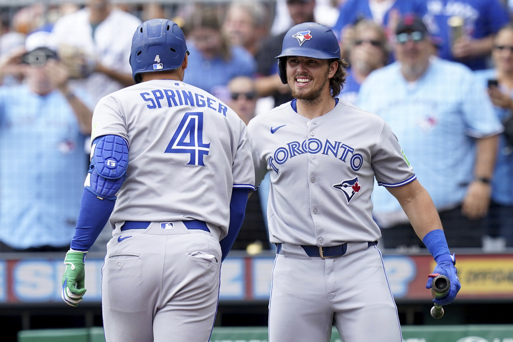 Toronto Blue Jays' George Springer, left, is greeted by Addison Barger, right, after hitting a home run during the first inning of a baseball game against the Pittsburgh Pirates Wednesday, Aug. 20, 2025, in Pittsburgh. (AP Photo/Matt Freed)