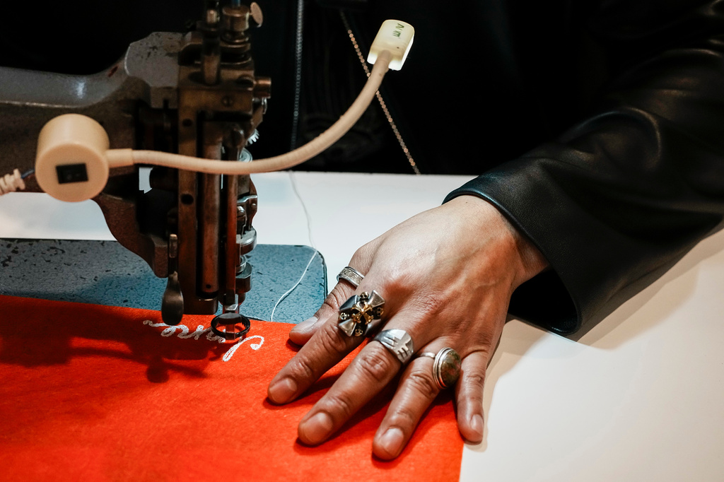 Tailor Marco Lema, 35, of Ecuador, works on a embroidery machine at Nordstrom headquarters in New York, Monday, March 23, 2026. (AP Photo/Eduardo Munoz Alvarez)