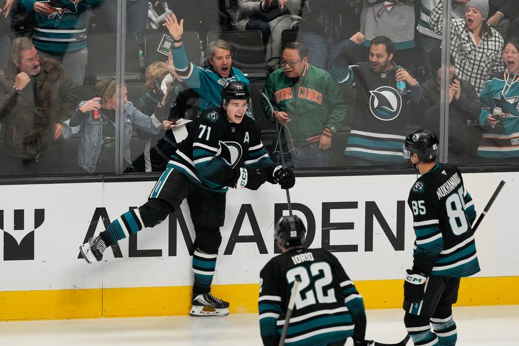 San Jose Sharks center Macklin Celebrini (71) celebrates after scoring against the Calgary Flames during the third period of an NHL hockey game in San Jose, Calif., Tuesday, Dec. 16, 2025. (AP Photo/Jeff Chiu)