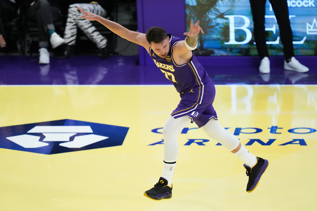 Los Angeles Lakers guard Luka Doncic celebrates his three-point basket during the first half of an NBA Cup basketball game against the Los Angeles Clippers Tuesday, Nov. 25, 2025, in Los Angeles. (AP Photo/Jae C. Hong)