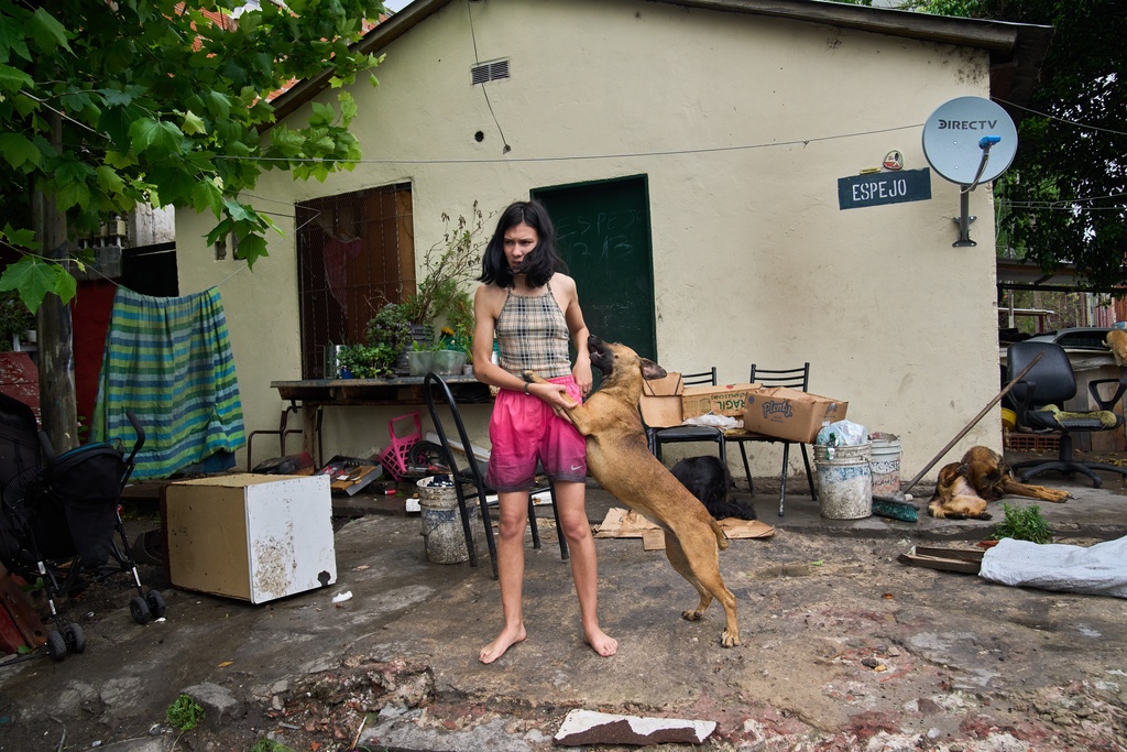 Abigail Rodriguez stands outside her home in the Isla Maciel neighborhood of Buenos Aires, Argentina, Friday, Oct. 24, 2025. (AP Photo/Rodrigo Abd)