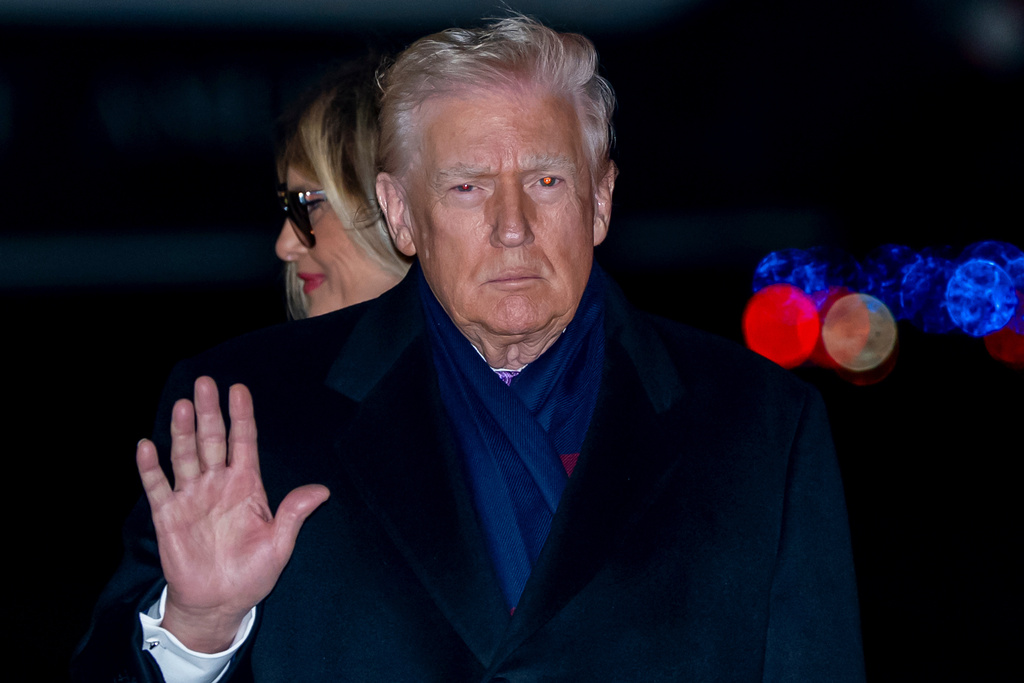 President Donald Trump waves as he and first lady Melania Trump arrive on Air Force One, Sunday, Nov. 30, 2025, at Joint Base Andrews, Md. (AP Photo/Alex Brandon)