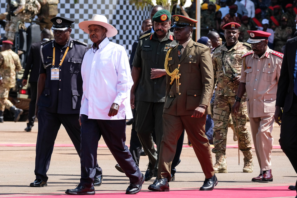 Uganda's long-time president Yoweri Museveni, 81, second from left, arrives for the inauguration ceremony for his seventh consecutive five-year term, in Kampala, Uganda, Tuesday, May 12, 2026. (AP Photo/Hajarah Nalwadda )
