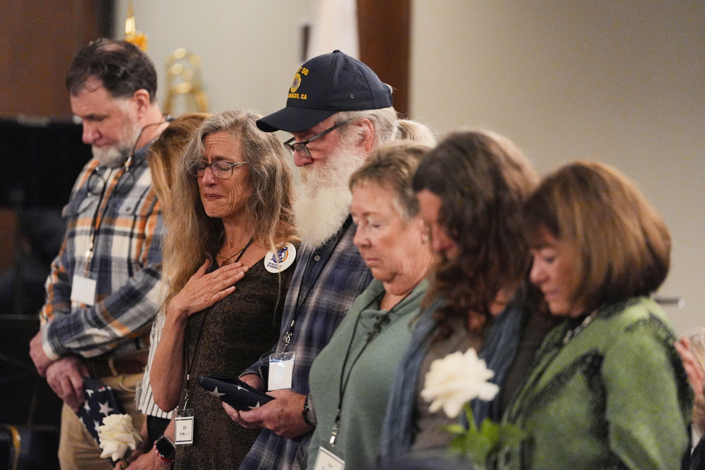 Attendees pray during a commemoration on the one-year anniversary of the Palisades Fire in the Pacific Palisades neighborhood of Los Angeles Wednesday, Jan. 7, 2026. (AP Photo/Jae C. Hong)