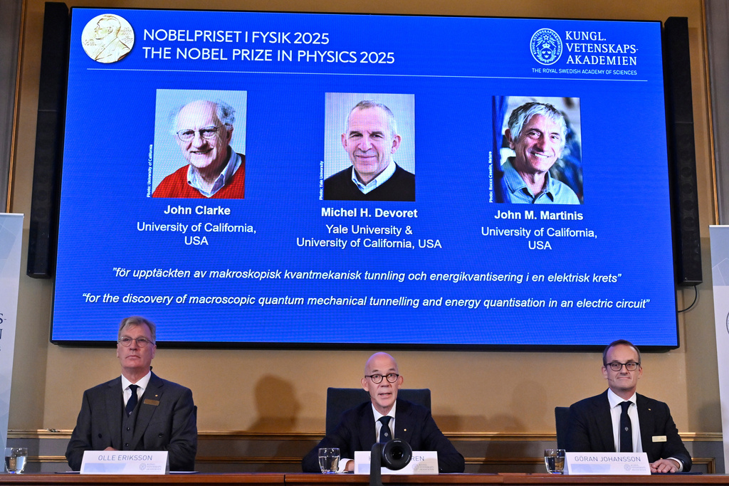 From left, Chair of the Nobel Committee for Physics Chair Olle Eriksson, Secretary General of the Swedish Academy of Sciences Hans Ellegren and Member of the Nobel Committee for Physics Goran Johansson announce John Clarke, Michel H Devoret and John M. Martinis, on screen behind, as the recipients the Nobel Prize in Physics, at the Nobel Assembly of the Karolinska Institutet, in Stockholm, Sweden, Tuesday, Oct. 7, 2025. (Christine Olsson/TT News Agency via AP)