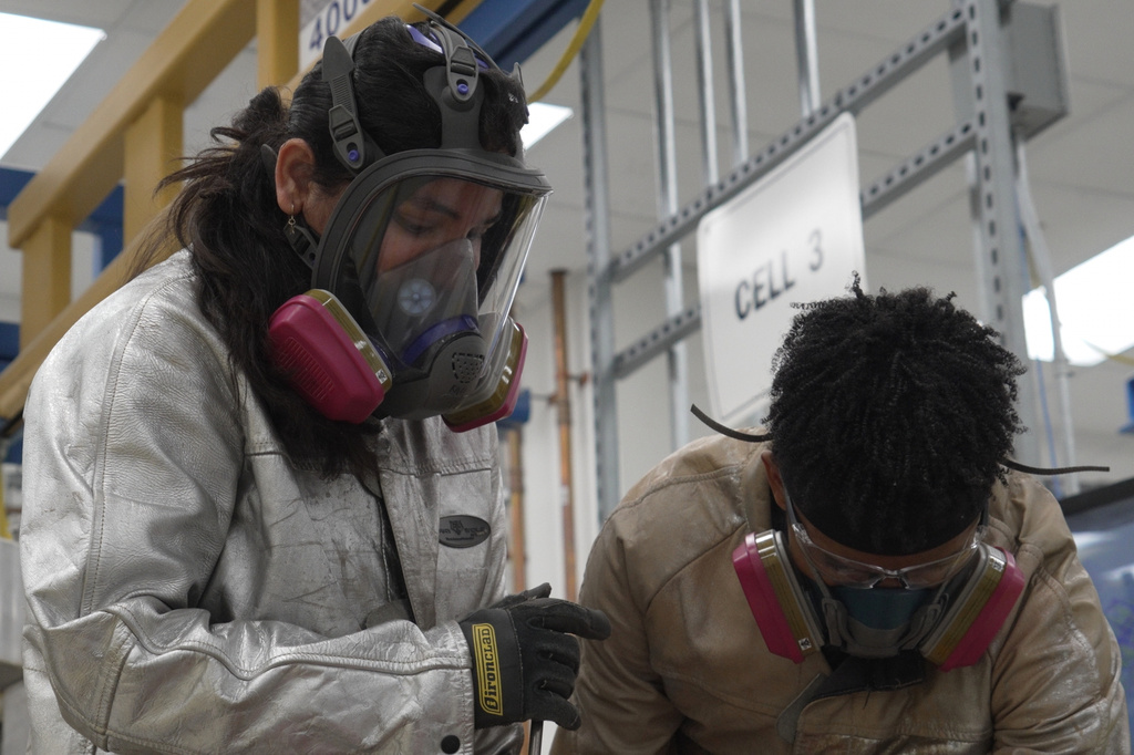 This image taken from video shows Phoenix Tailings' workers clad in personal protection equipment as they harvest an alloy on Wednesday, July 22, 2026, at the company's rare earth elements refinery in Exeter, N.H. (AP Photo/Rodrique Ngowi)