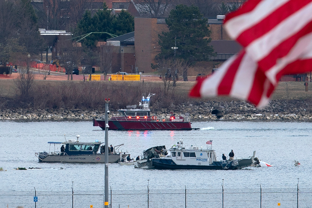 FILE - A diving team and police boat is seen near a wreckage site in the Potomac River, from Ronald Reagan Washington National Airport, Jan. 30, 2025, in Arlington, Va. (AP Photo/Jose Luis Magana, File)