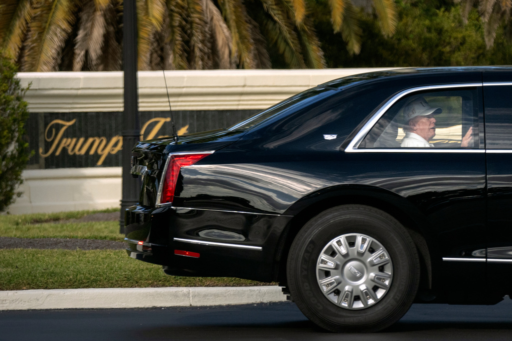 President Donald Trump rides in his limousine as he leaves the Trump International Golf Club, Sunday, Feb. 8, 2026, in West Palm Beach, Fla. (AP Photo/Mark Schiefelbein)