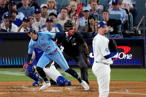 Toronto Blue Jays' Daulton Varsho follows through on a triple off Los Angeles Dodgers pitcher Blake Snell, right, during the fourth inning in Game 5 of baseball's World Series, Wednesday, Oct. 29, 2025, in Los Angeles. (AP Photo/David J. Phillip) Toronto Blue Jays' Daulton Varsho follows through on a triple off Los Angeles Dodgers pitcher Blake Snell, right, during the fourth inning in Game 5 of baseball's World Series, Wednesday, Oct. 29, 2025, in Los Angeles. (AP Photo/David J. Phillip)