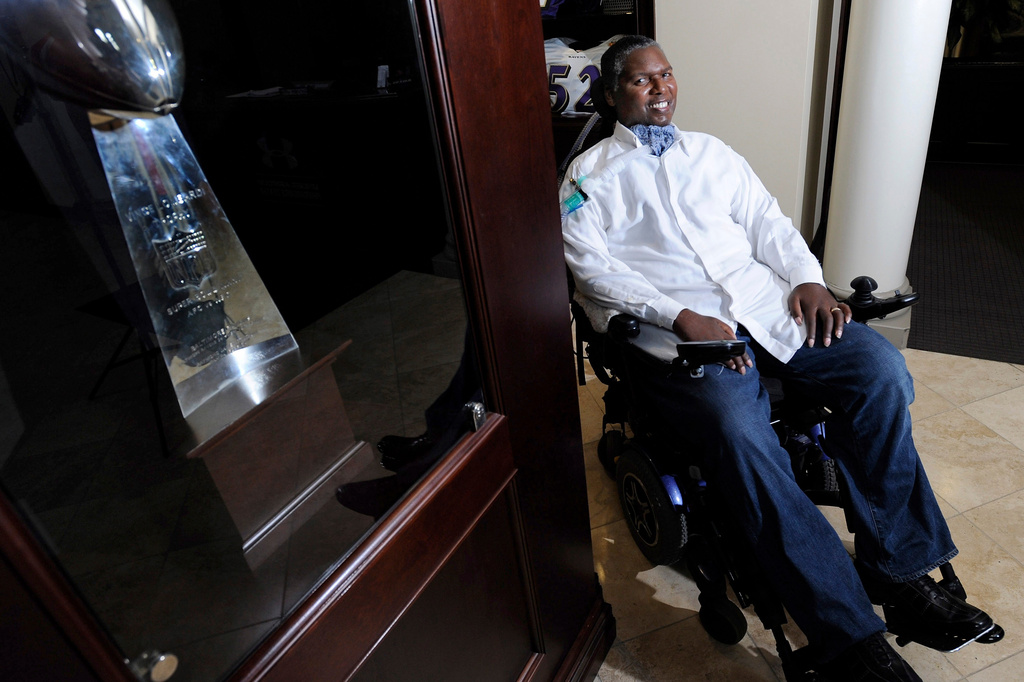 FILE - O.J. Brigance, former linebacker and current director of player development for the Baltimore Ravens, sits near the NFL football team's Vince Lombardi Trophy from the 2001 Super Bowl, in which he played, at the NFL football team's practice facility in Owings Mills, Md., Sept. 5, 2012. (AP Photo/Steve Ruark, File)