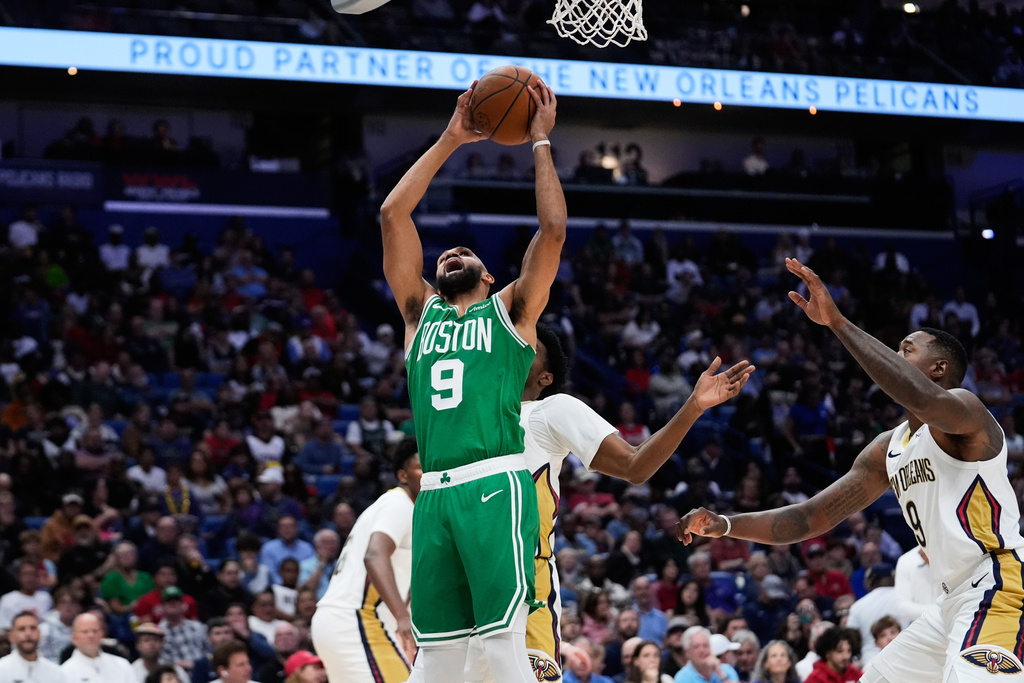 Boston Celtics guard Derrick White (9) goes to the basket against the New Orleans Pelicans in the second half of an NBA basketball game, Monday, Oct. 27, 2025, in New Orleans. (AP Photo/Gerald Herbert)