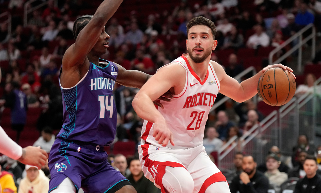 Houston Rockets center Alperen Sengun (28) controls the ball against Charlotte Hornets forward Moussa Diabate (14) during the first half of an NBA basketball game, Thursday, Feb. 5, 2026, in Houston. (AP Photo/ Karen Warren)