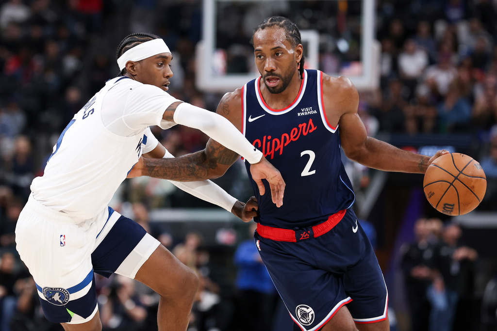 Los Angeles Clippers forward Kawhi Leonard (2) dribbles against Minnesota Timberwolves forward Jaden McDaniels, left, during the first half of an NBA basketball game, Wednesday, March 11, 2026, in Inglewood, Calif. (AP Photo/Jessie Alcheh)