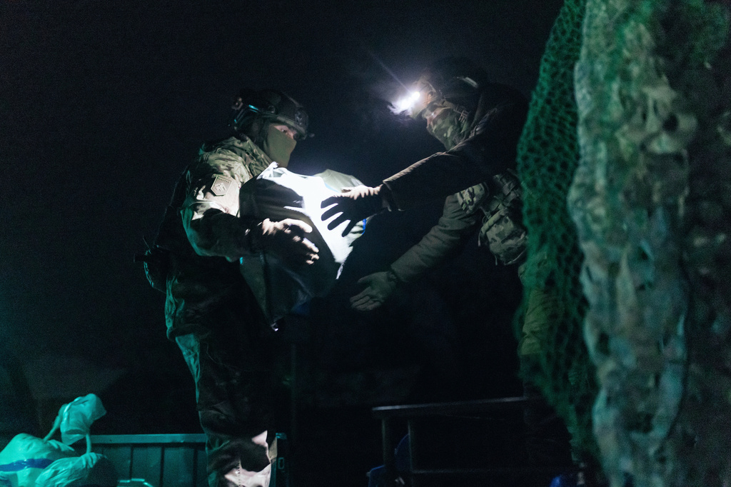 Soldiers from Ukraine's Khartia brigade load ammunition onto a combat ground drone bound for the front line in Kharkiv region, Ukraine, Jan. 27, 2026. (AP Photo/Nikoletta Stoyanova)
