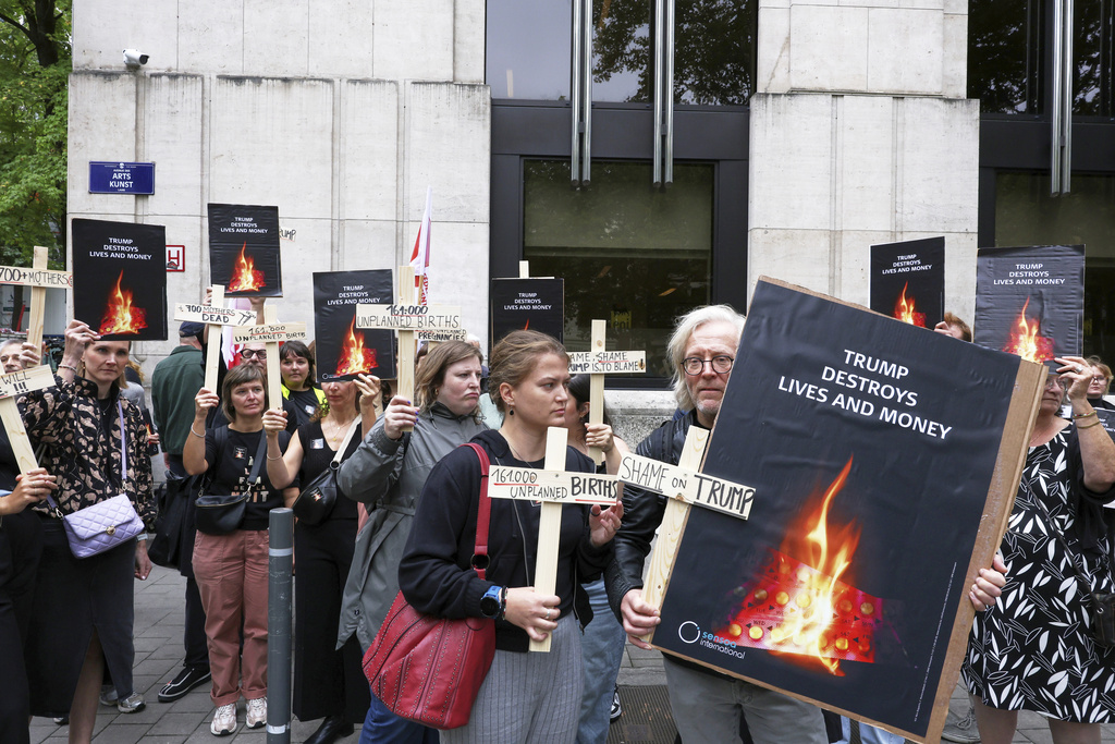 Participants from various women's rights organizations hold signs as they demonstrate regarding the destruction of family planning supplies stockpiled in Belgium, near the U.S. embassy in Brussels, Thursday, Sept. 18, 2025. (AP Photo/Omar Havana)