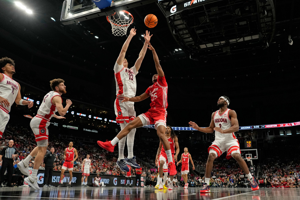 Houston's Mercy Miller (25) shoots over Arizona's Motiejus Krivas (13) during the first half of an NCAA college basketball game in the championship of the Big 12 Conference tournament Saturday, March 14, 2026, in Kansas City, Mo. (AP Photo/Charlie Riedel)