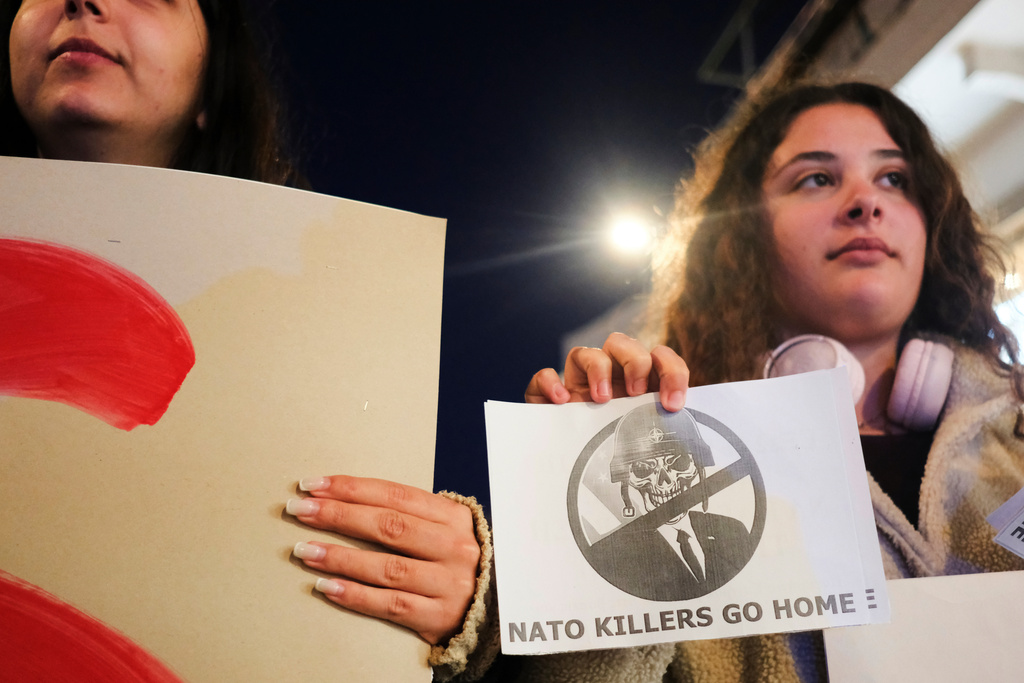 Protesters take part in an anti-war rally in Chania, Greece, opposing the docking of the aircraft carrier USS Gerald R. Ford at the nearby Souda Bay naval base on the southern island of Crete, Tuesday, Feb. 24, 2026. (AP Photo/Giannis Angelakis)