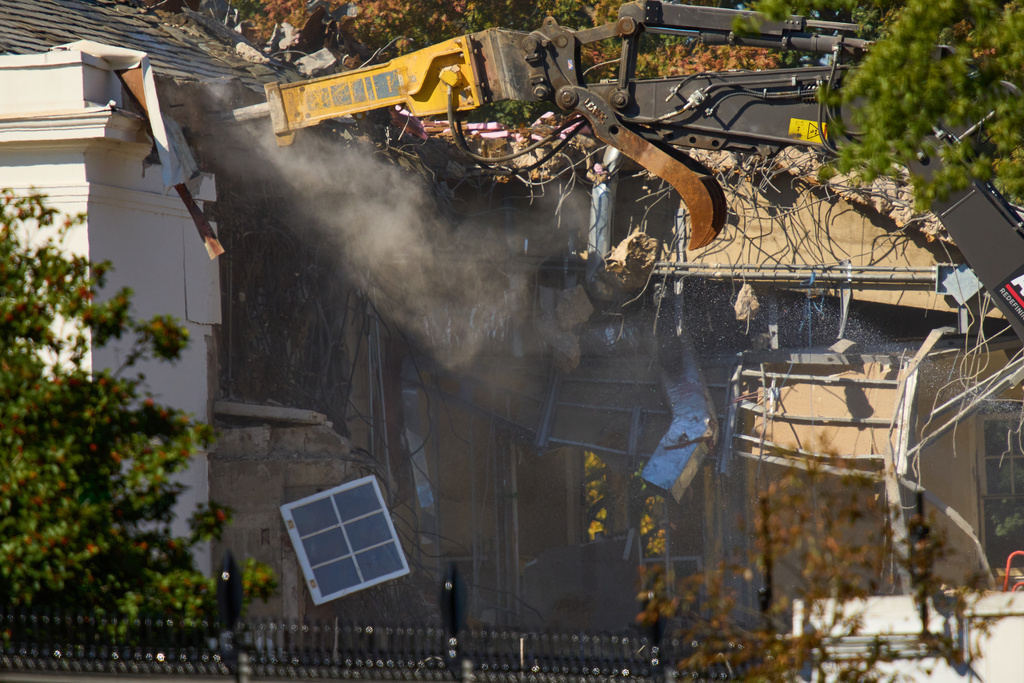 A window dangles from the East Wing as work continues on the demolition of a part of the East Wing of the White House, Tuesday, Oct. 21, 2025, in Washington, before construction of a new ballroom. (AP Photo/Jacquelyn Martin)