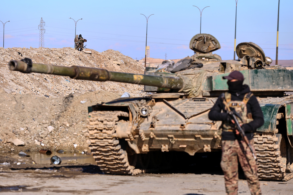 Soldiers of the Kurdish-led, U.S.-backed Syrian Democratic Forces (SDF) deploy with armoured military vehicles to secure roads leading to Gweiran Prison which houses men accused of being an Islamic State (ISIS) fighters in Hassakeh, northeastern Syria, Monday, Jan. 19, 2026. (AP Photo/Baderkhan Ahmad)