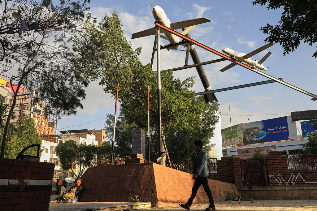 FILE - A Yemeni man walks past a monument featuring mock rockets in Sanaa, Yemen, July 28, 2026. (AP Photo/Osamah Abdulrahman, File)