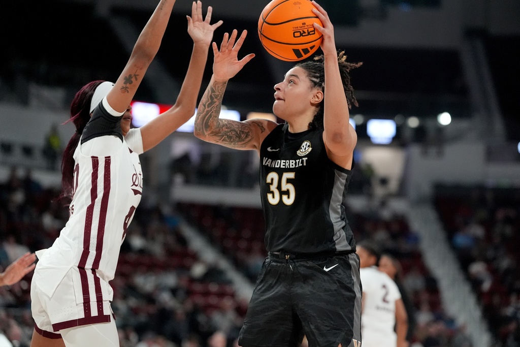 Vanderbilt forward Sacha Washington (35) attempts a shot past the defense of Mississippi State forward Madison Francis, left, during the first half of an NCAA college basketball game, Thursday, Jan. 15, 2026, in Starkville, Miss. (AP Photo/Rogelio V. Solis)