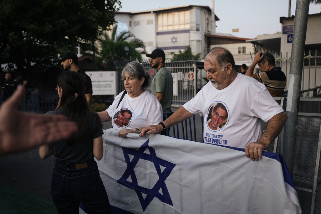 People await the arrival of a coffin handed over to Israel from Gaza that Hamas says contains the remains of Hadar Goldin, a soldier killed in Gaza in 2014, whose remains have been held there since, at the Abu Kabir Forensic Institute in Tel Aviv, Israel, Sunday, Nov. 9, 2025. (AP Photo/Mahmoud Illean)