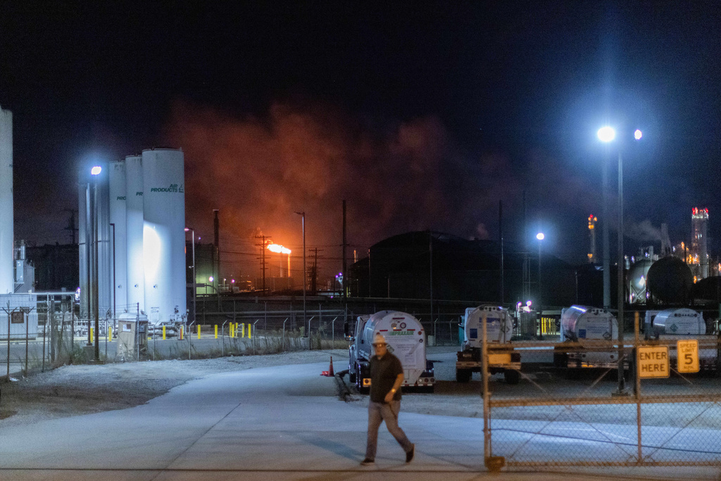 Flames rise from the Chevron refinery in El Segundo, Calif., Thursday, Oct. 2, 2025. (AP Photo/Ethan Swope)
