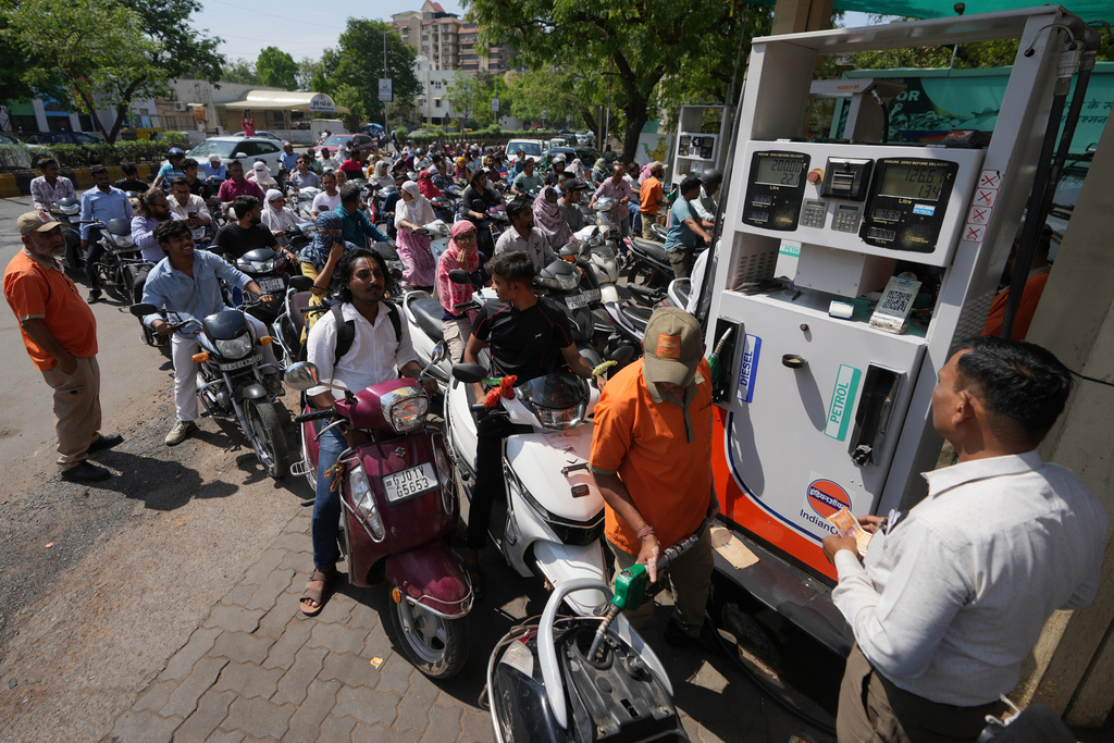 Motorists queue up to get fuel at a pump, fearing a possible fuel shortage due to the US Iran war, in Ahmedabad, India, Monday, March 23, 2026. (AP Photo/Ajit Solanki)