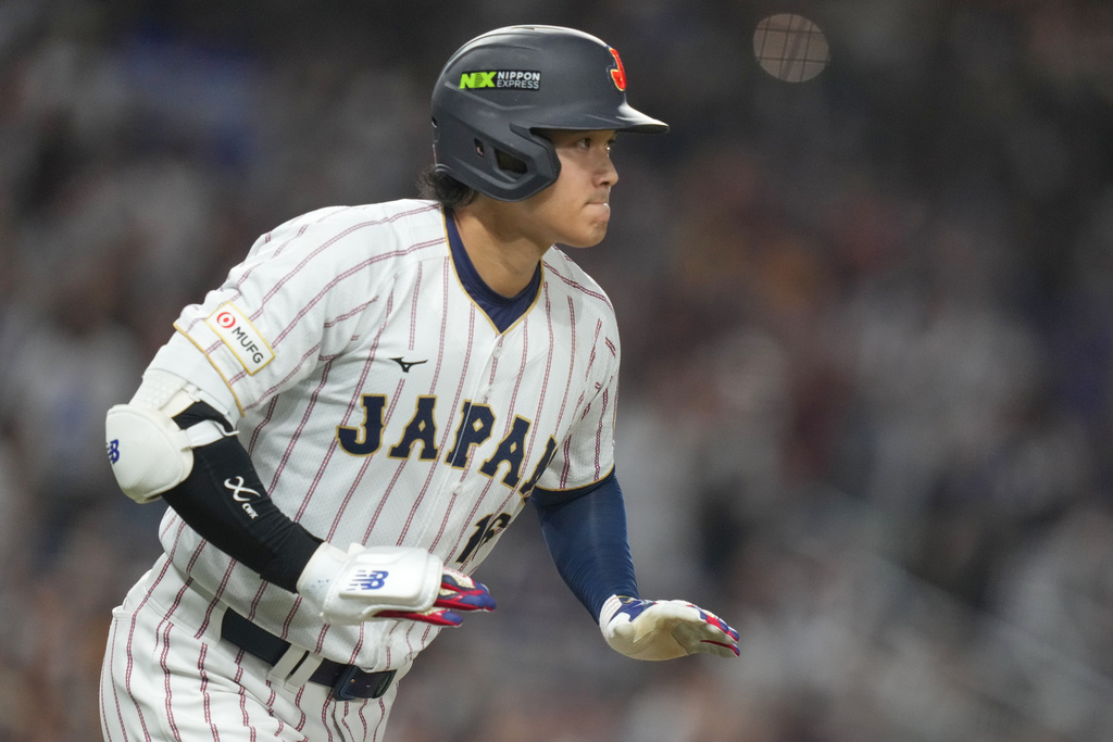 Japan's Shohei Ohtani runs as he hits a single home run during the first inning against Venezuela of a World Baseball Classic quarterfinal game, Saturday, March 14, 2026, in Miami. (AP Photo/Lynne Sladky)