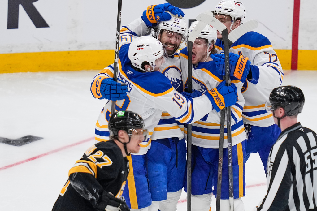 Buffalo Sabres right wing Alex Tuch (89) celebrates his goal with teammates as Boston Bruins defenseman Hampus Lindholm (27) skates past during the third period in Game 3 of a first-round NHL hockey Stanley Cup playoff series, Thursday, April 23, 2026, in Boston. (AP Photo/Charles Krupa)