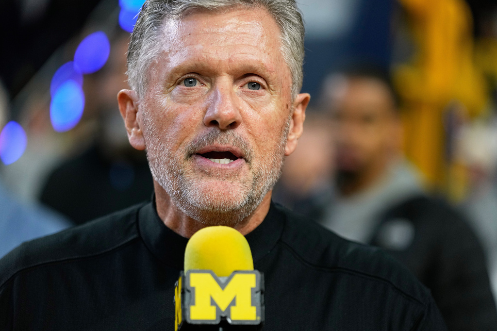 FILE - Michigan Football head coach Kyle Whittingham speaks during the first half of an NCAA college basketball game between Michigan and Southern California, Jan. 2, 2026, in Ann Arbor, Mich. (AP Photo/Ryan Sun, File)